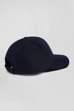 Navy blue cap with bow tie emblem