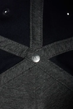 Navy blue cap with bow tie emblem
