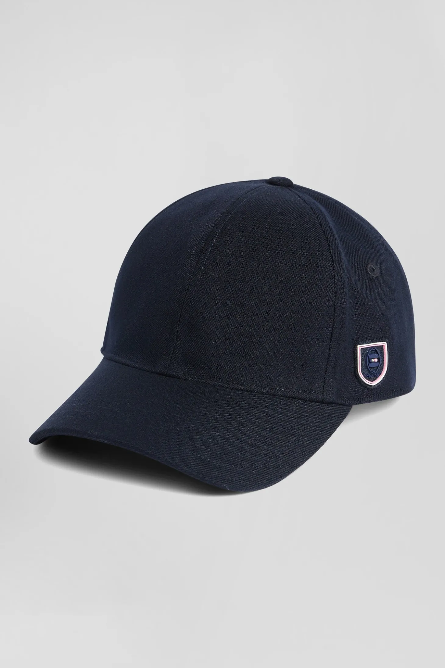 Navy blue cap with rubber badge and tricolour trim