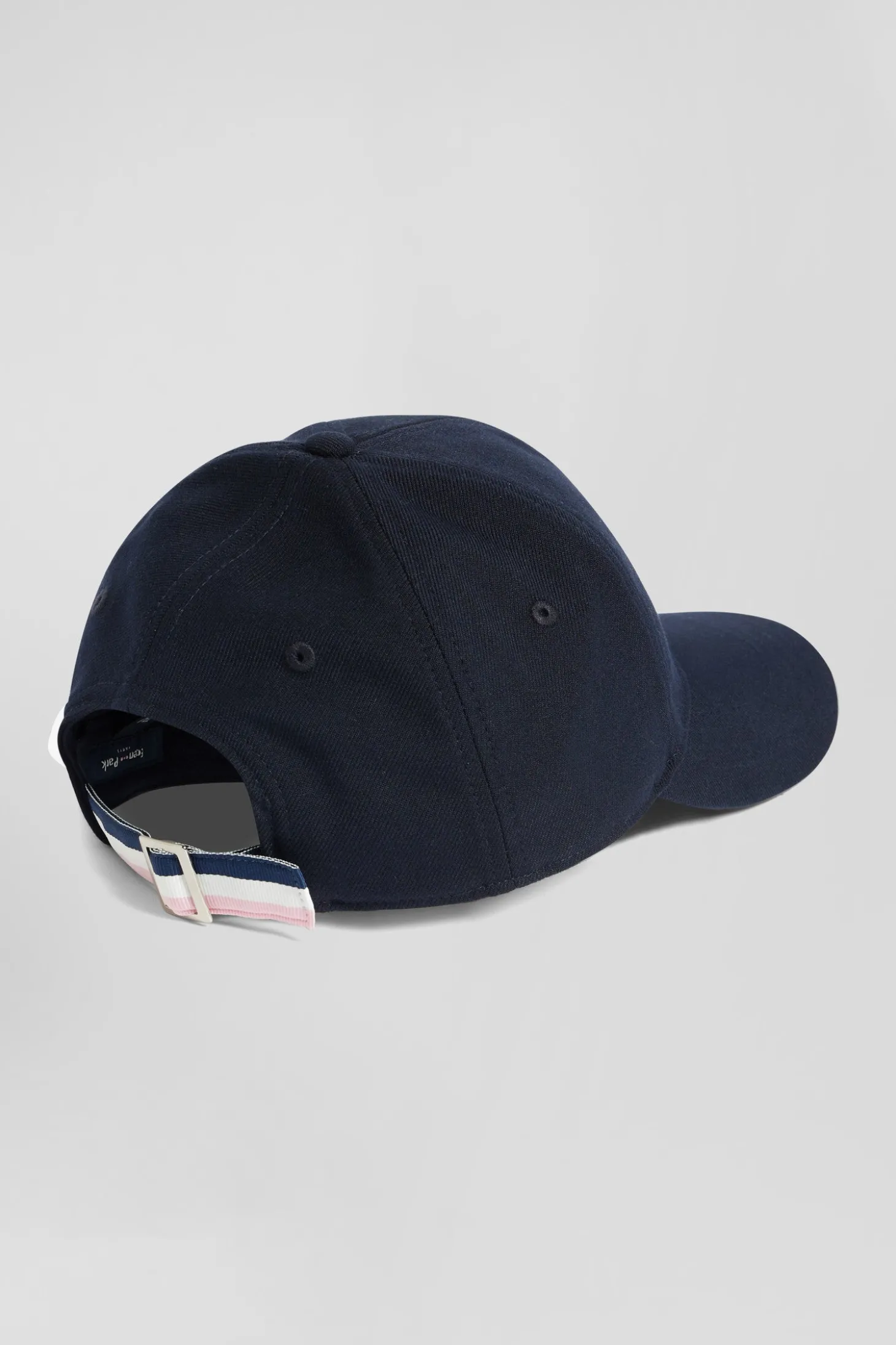 Navy blue cap with rubber badge and tricolour trim