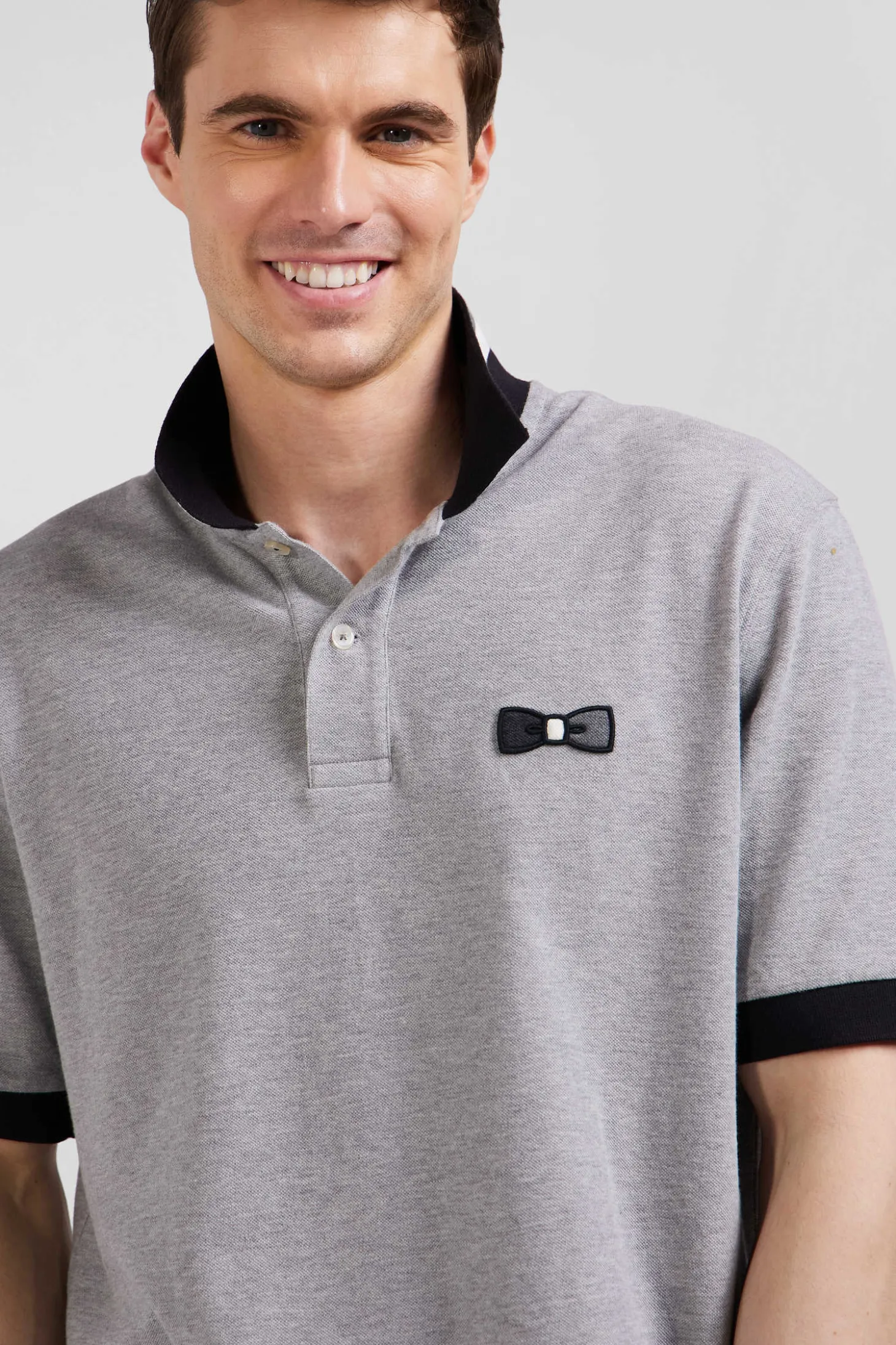 Oversize black short-sleeved cotton piqué polo shirt with tricolor details