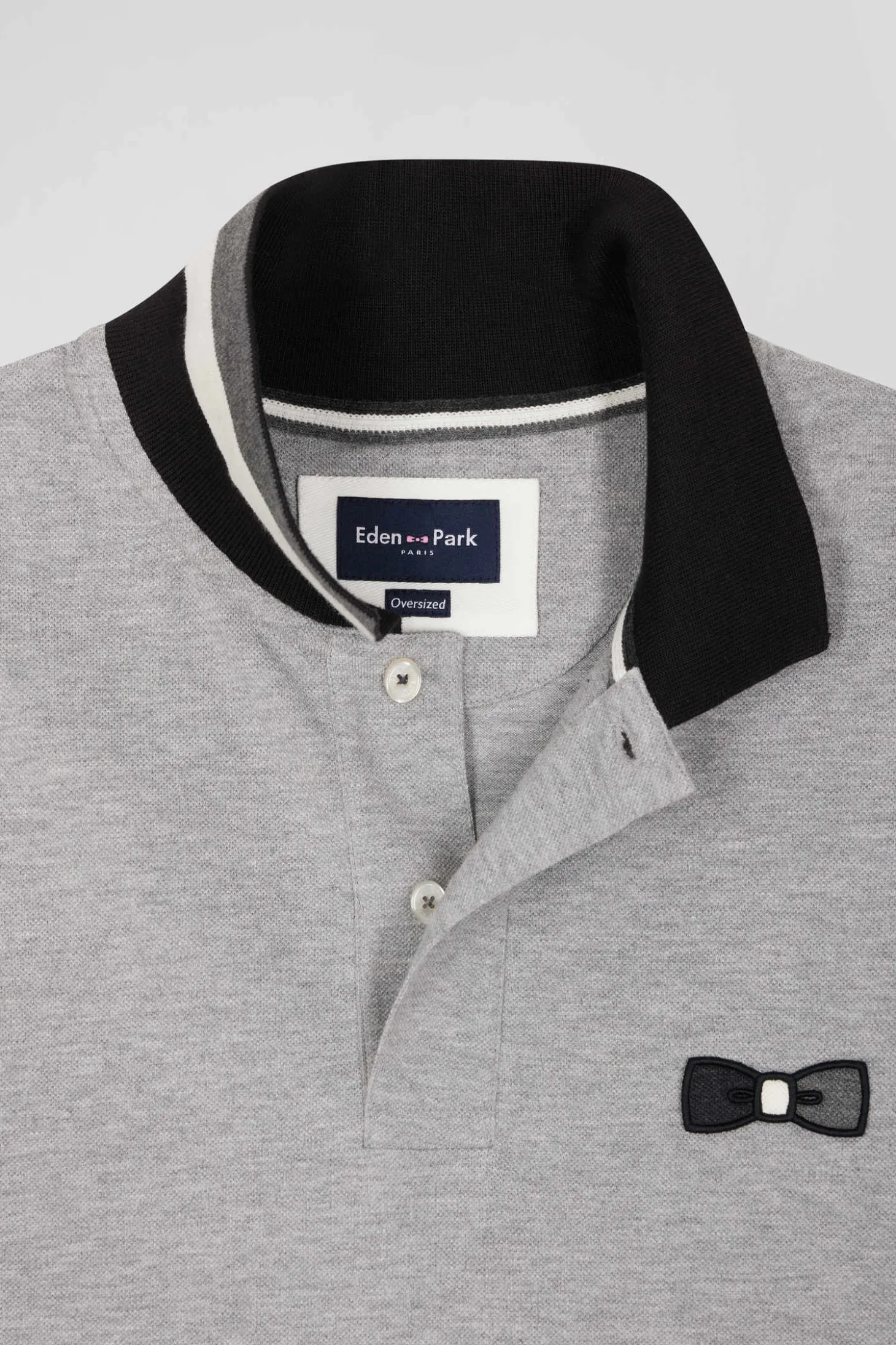Oversize black short-sleeved cotton piqué polo shirt with tricolor details