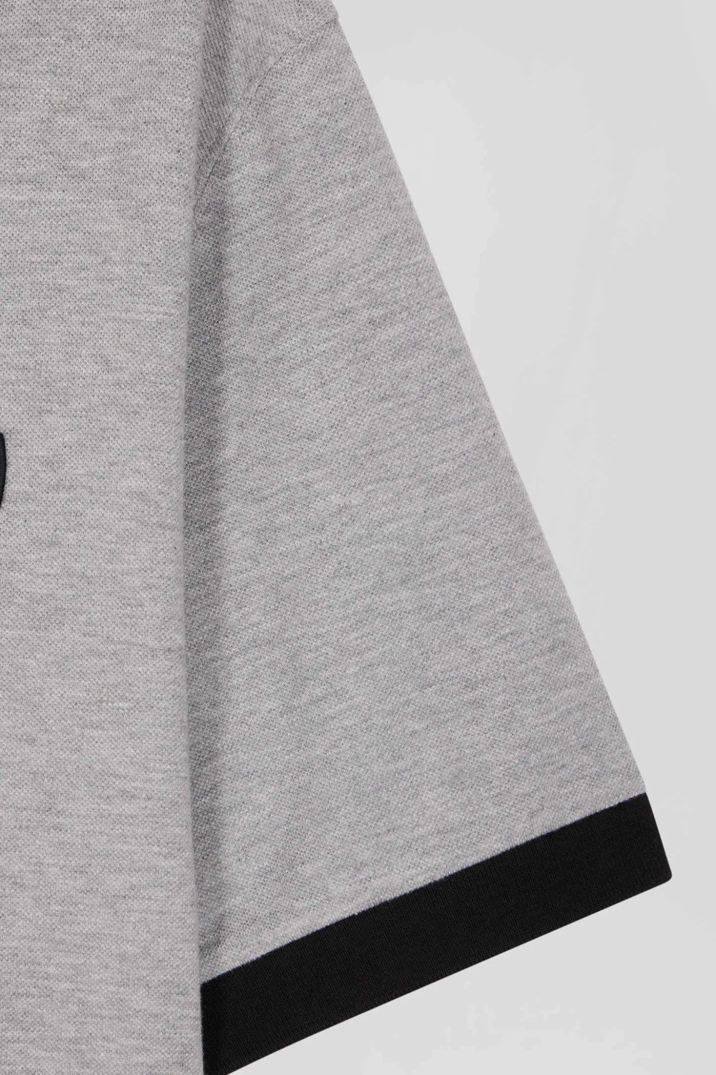 Oversize black short-sleeved cotton piqué polo shirt with tricolor details