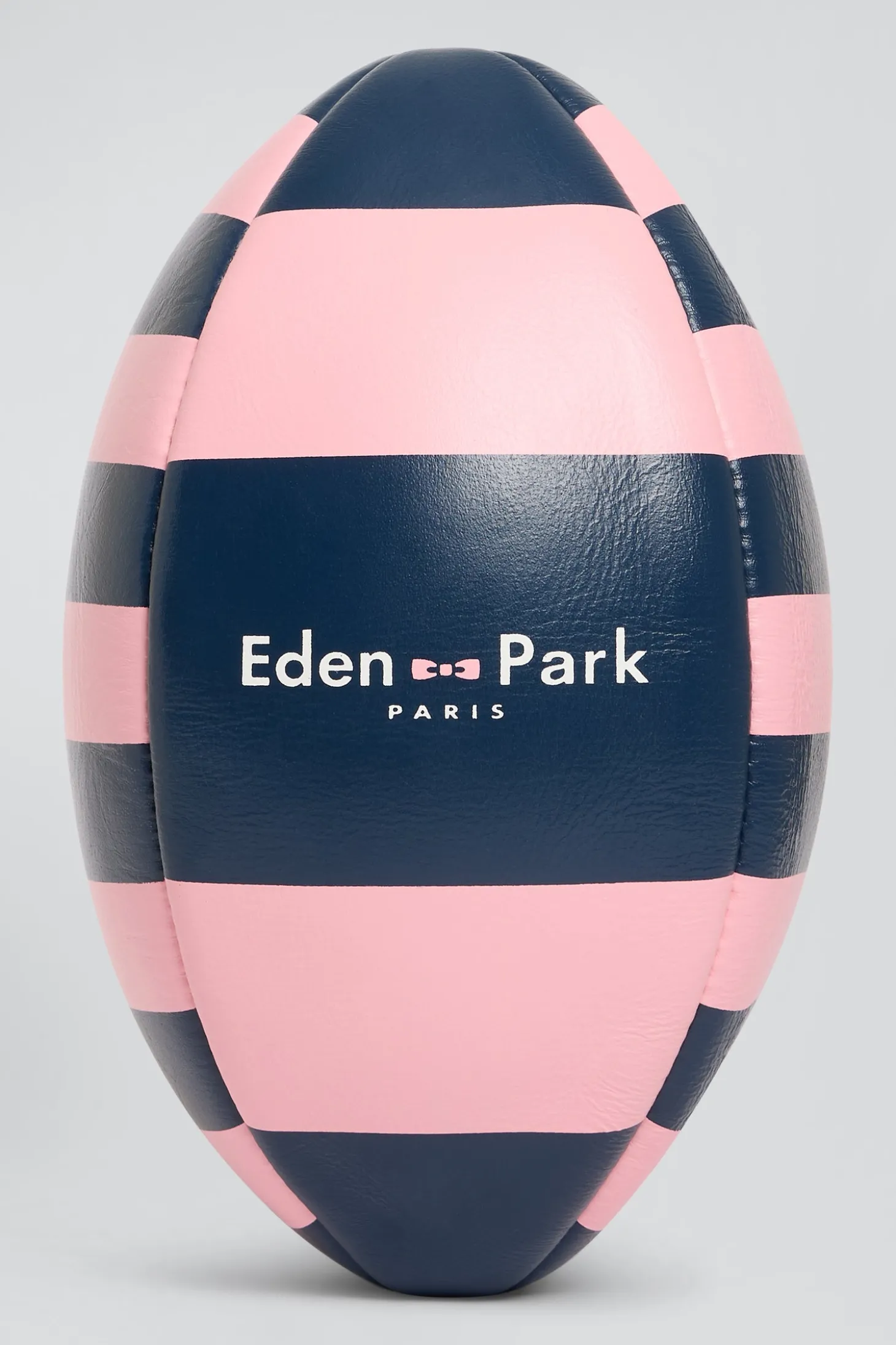 Pink leather rugby ball with striped quarters